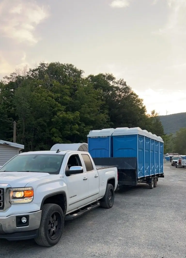 Pickup truck towing a trailer loaded with A1 portable toilets