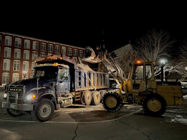 A1 dump truck and loader clearing snow at night