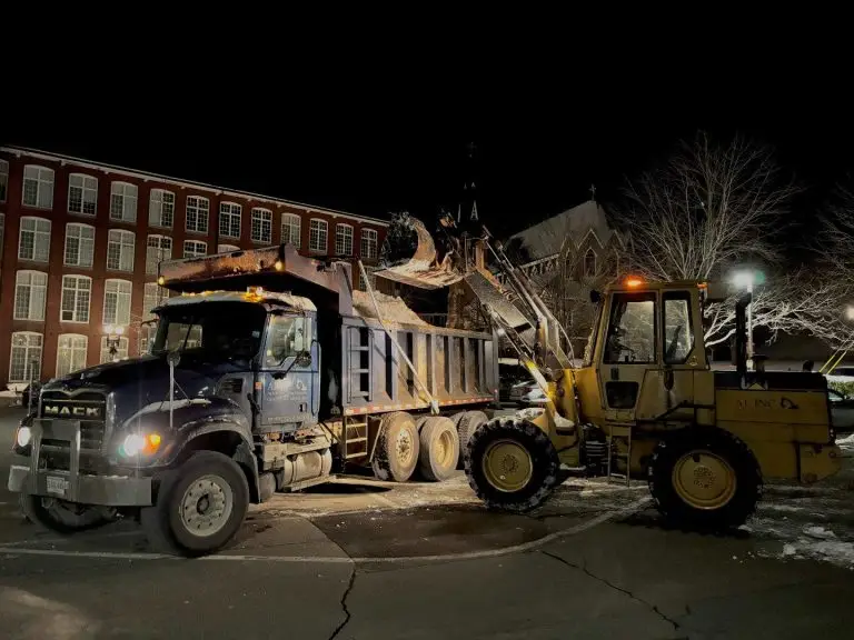 A1 dump truck and loader clearing snow at night