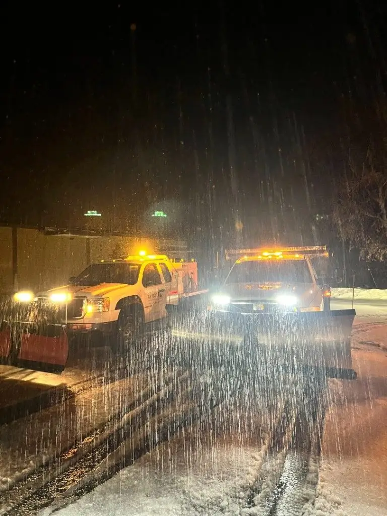 A1 plow trucks working at night in falling snow